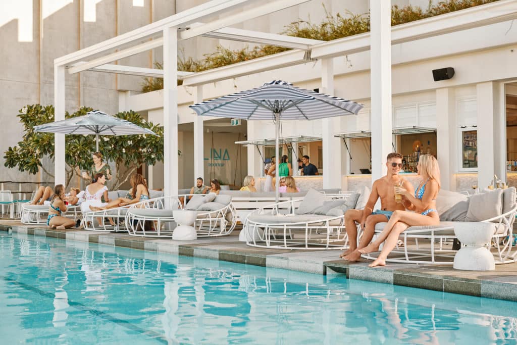 a photo of people sitting around a pool
