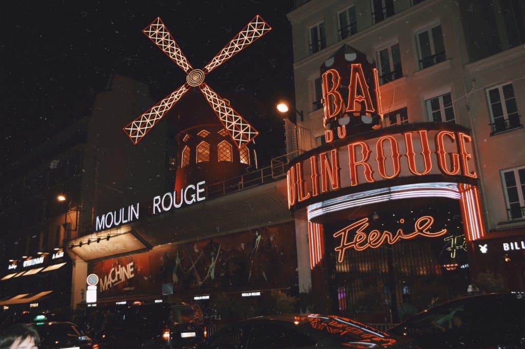 Picture taken at night of lit up Moulin Rouge. 