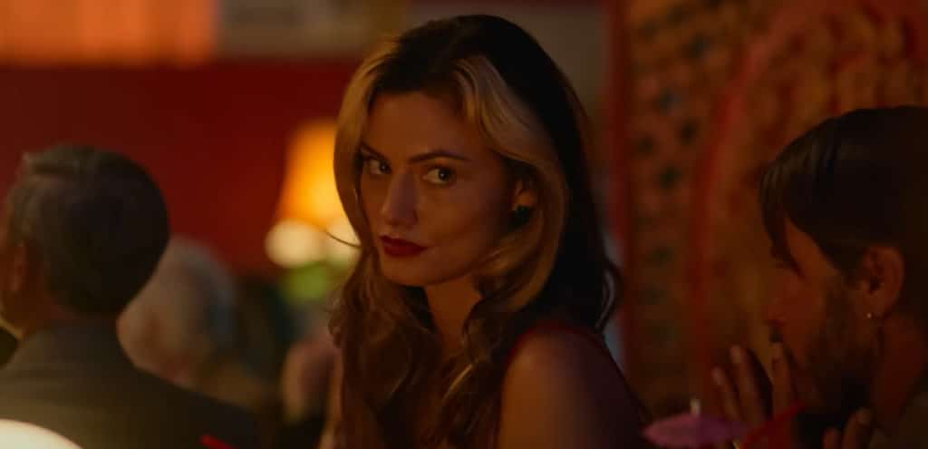 a photo of phoebe tonkin looking at the camera in netflix's boy swallows universe tv series