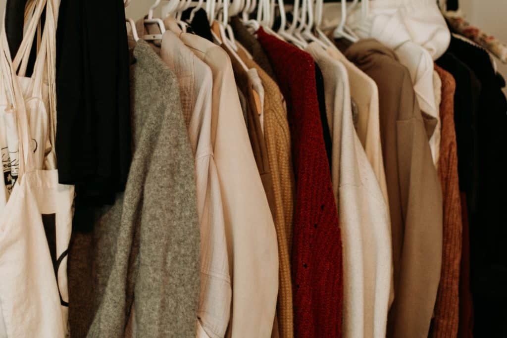 a photo of clothes on a rack at an op shop