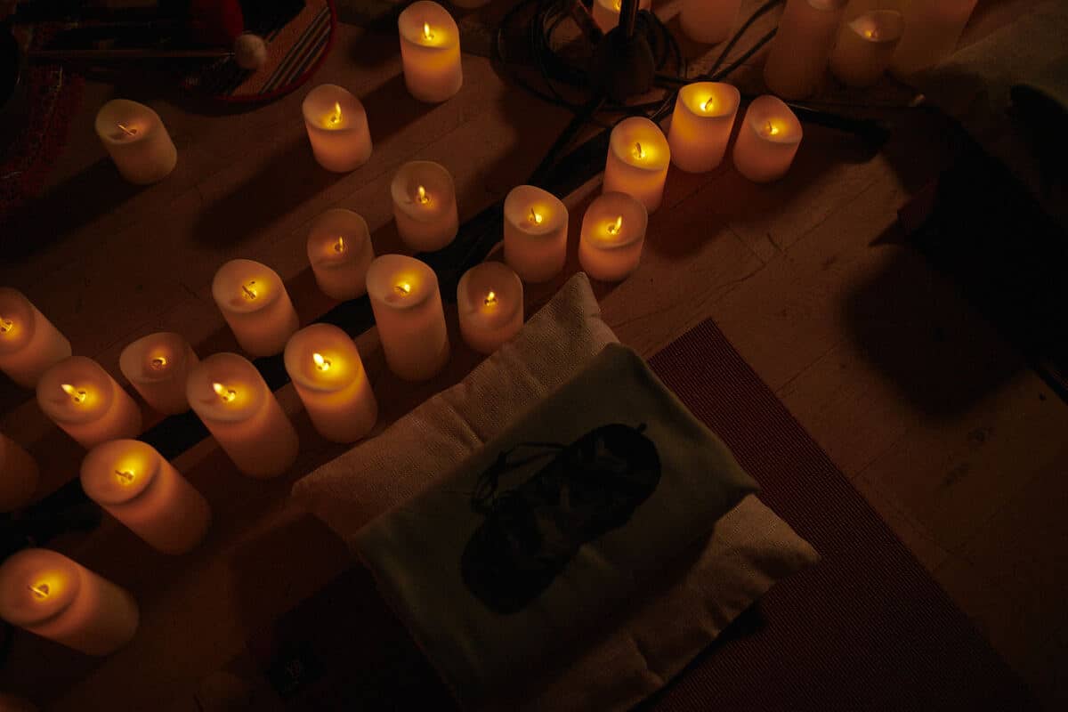 Candles surrounding meditation equipment