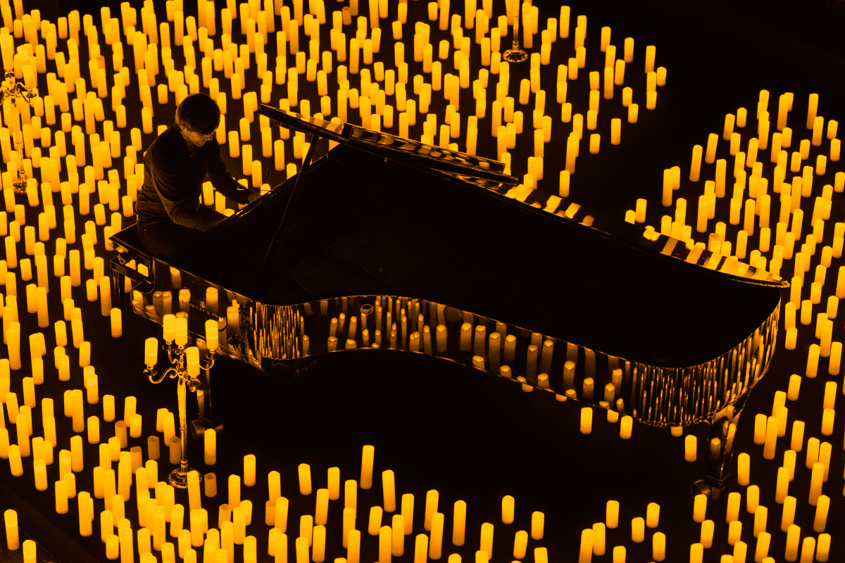 A pianist performing in a sea of candles