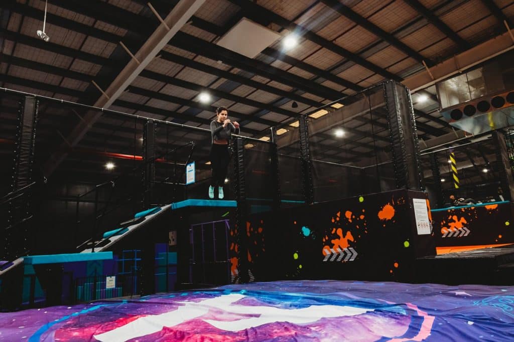 a photo of a woman about to jump onto a giant trampoline