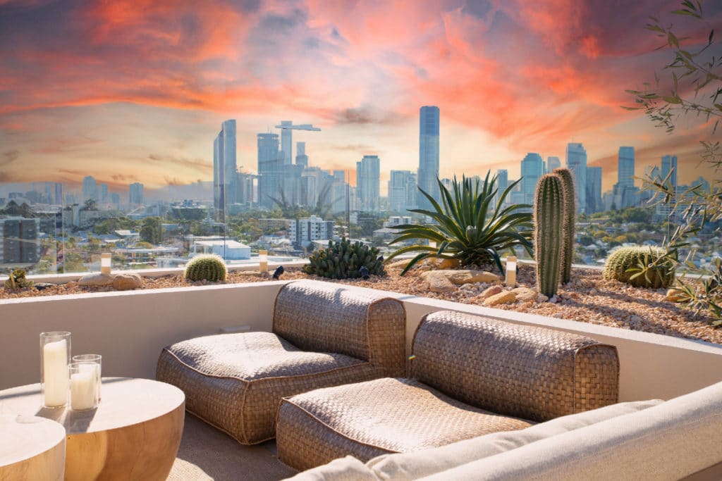 a photo of the brisbane city skyline at sunsets taken from a desert-inspired rooftop bar